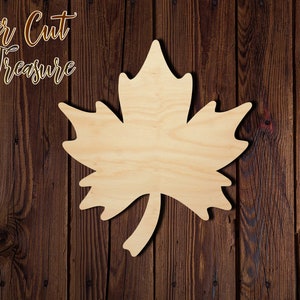 May include: A wooden maple leaf cutout, perfect for crafting projects. The leaf is unpainted and has a natural wood finish.