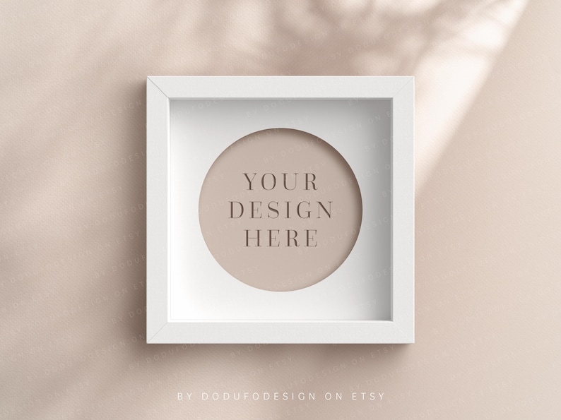 May include: White square frame with a circular cutout. The cutout has a light brown background with the text "YOUR DESIGN HERE" in a light brown font.