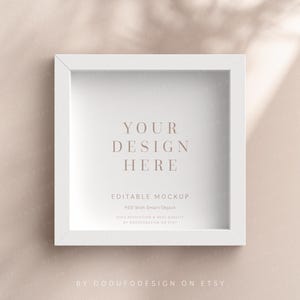 May include: White frame mockup with the text "YOUR DESIGN HERE" and "EDITABLE MOCKUP PSD with Smart Object High resolution & best quality By OddUfoDesign on Etsy" on a light beige background.