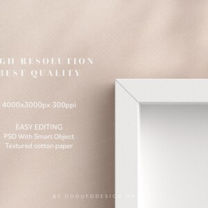 May include: A white picture frame with a white mat on a light pink textured background. The frame is 4000x3000 pixels and 300ppi. The text "HIGH RESOLUTION BEST QUALITY" is at the top of the image. The text "EASY EDITING PSD With Smart Object Textured cotton paper" is below the frame. The text "BY DODUFODESIGN ON" is at the bottom of the image.