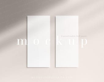 May include: Two vertical rectangular sheets of white paper, each measuring 10.16x22.86 cm, displayed side by side. The paper is blank and features a smooth, matte texture. The text "Customizable 4x9 paper" is printed in the centre of the right sheet.