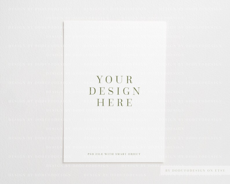 May include: A white mockup with the text "YOUR DESIGN HERE" in green text. The text "PSD FILE WITH SMART OBJECT" is also in green text at the bottom of the mockup. The text "BY DODUTODESIGN ON ETSY" is in green text at the bottom right corner of the mockup.
