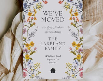 May include: A moving announcement card with floral border, featuring the text "WE'VE MOVED" and "The Lakeland Family." The card includes the new address and a house icon, with a design of yellow, pink, and blue flowers.