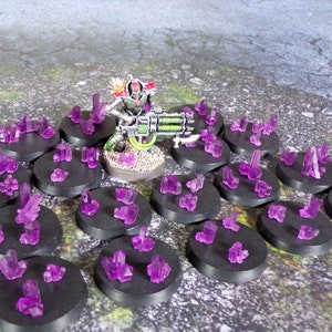 May include: A miniature figure of a robot holding a large gun, surrounded by 18 small purple crystal clusters on black bases.