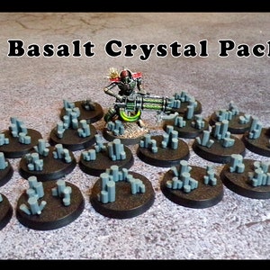 May include: 65 Basalt Crystal Pack for tabletop gaming. The pack includes 20 grey crystal bases with a variety of shapes and sizes. The bases are perfect for adding a touch of realism to your miniature models.