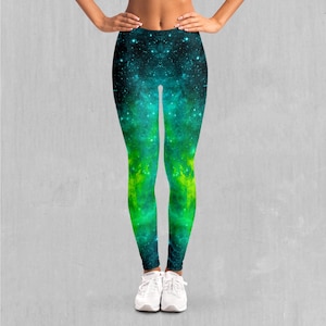 May include: Green and blue leggings with a galaxy print. The leggings have a black background with green and blue nebulae and stars.