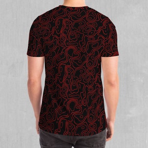 May include: A black t-shirt with a red abstract pattern of swirling lines.