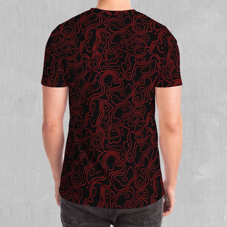 May include: A black t-shirt with a red abstract pattern of swirling lines.