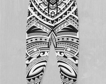 May include: Black and white sweatpants featuring a tribal pattern. The pattern is a geometric design with repeating shapes and lines.