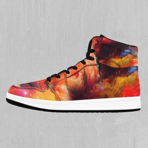 May include: High-top sneakers with a colorful abstract print featuring shades of red, orange, yellow, and blue. The print resembles a galaxy or nebula.
