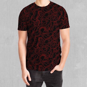 May include: A black t-shirt with a red abstract pattern of swirling lines.