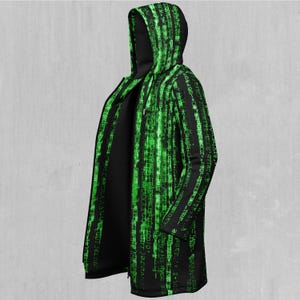 May include: Black hooded jacket with a long zipper and green digital code print.
