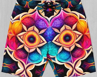May include: Colorful patterned swim trunks with a geometric design featuring bright colors like yellow, pink, blue, and purple.