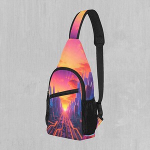 Puede incluir: Una bandolera negra y rosa con un diseño de ciudad y puesta de sol. La bolsa tiene un bolsillo con cremallera y un bolsillo de malla en el lateral.