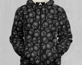 May include: Black zip-up hoodie with a repeating skull pattern. The interior lining of the hood is a cream color. The hoodie has a full zipper and a hood. The pattern is a grayscale design of skulls.