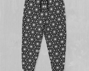 May include: Black sweatpants with a white geometric pattern. The pattern is made up of repeating triangles and stars.