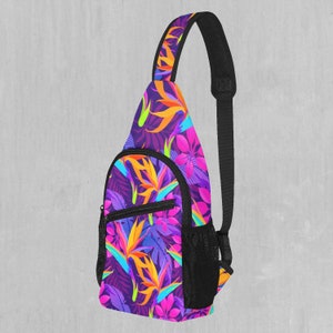 May include: A purple, pink, orange and green floral print sling bag with a black adjustable strap and mesh pocket.