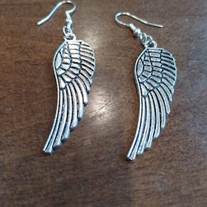 Silver colored angel wing earrings