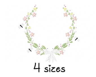 May include: A floral wreath with a white bow in the center. The wreath is made of green leaves and pink and yellow flowers. The text "4 sizes" is below the wreath.