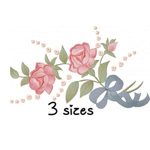 May include: Embroidered design featuring two pink roses with green leaves and a blue ribbon. The design is surrounded by a string of pearls. The text "3 sizes" is written below the design.