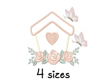 May include: Embroidered design of a pink birdhouse with a heart, surrounded by pink roses and butterflies. The text "4 sizes" is below the design.