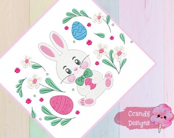 May include: Embroidered design featuring a white bunny holding a pink Easter egg, surrounded by green leaves, pink and white flowers, and blue and pink Easter eggs. The design includes the text "Candy Designs".