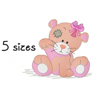 May include: Embroidered design of a pink and brown teddy bear with a pink bow and a patch over one eye. The text "5 sizes" is below the bear.