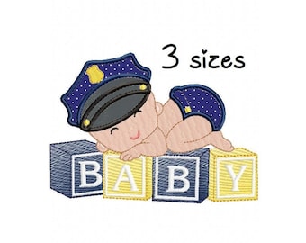 May include: Embroidered design of a baby wearing a police officer's hat, lying on top of blocks that spell out "BABY". The design comes in 3 sizes.
