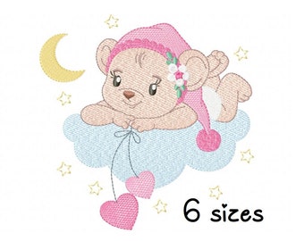 May include: Embroidered design of a pink bear wearing a pink hat with a flower on top, sleeping on a blue cloud with a crescent moon and stars in the background. The bear is holding two pink hearts on a string.
