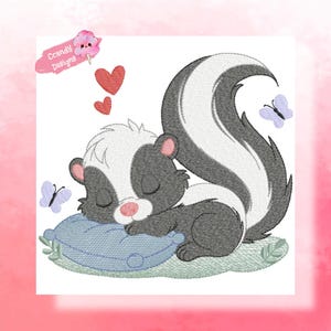 May include: An embroidered design of a sleeping skunk on a blue pillow, with two red hearts and two butterflies. The skunk is black, white, and gray, with closed eyes and a pink nose. The design includes the text "Ccandy Designs".