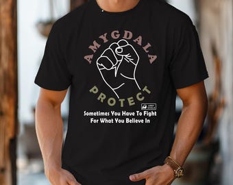 May include: Black t-shirt with the words "AMYGDALA PROTECT" in a circular design around a clenched fist graphic. The text "Sometimes You Have To Fight For What You Believe In" is below the graphic.