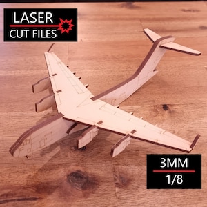 May include: A wooden model of a large cargo plane, with intricate details and a 3MM (1/8 inch) thickness. The model is made of light brown wood and is ready to be assembled.