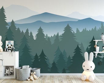 May include: A nursery room with a forest mural featuring a blue and green color scheme. The mural depicts a mountain range with trees in the foreground. There are two white bunny lamps, a white dresser with drawers, and a shelf with decorative items.