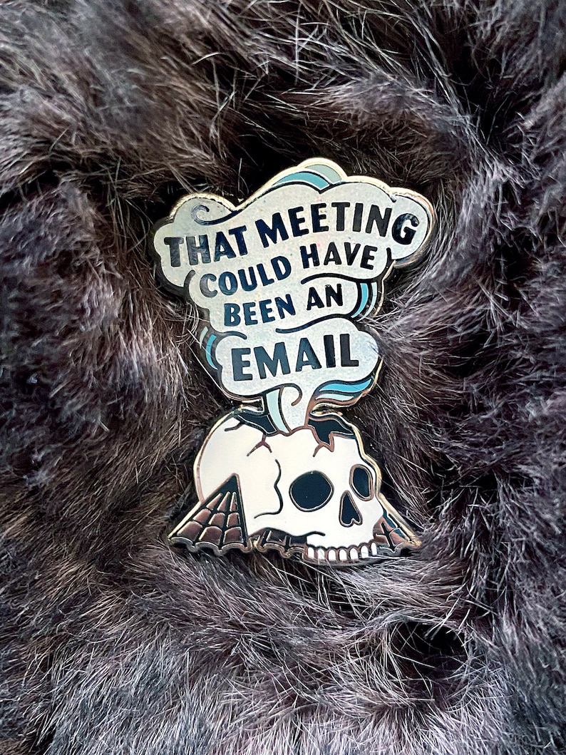 May include: Gold-colored enamel pin with a white skull and a speech bubble that says "That meeting could have been an email".
