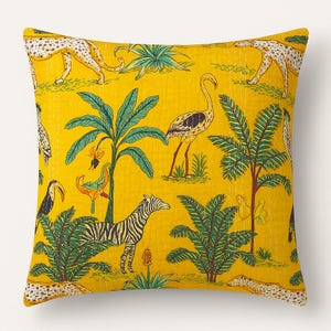 May include: Yellow decorative throw pillow with a jungle-themed pattern. The design features zebras, leopards, flamingos, toucans, and palm trees. The pillow has a quilted texture.
