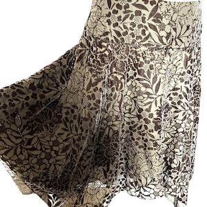 May include: A brown and cream floral patterned skirt with a flowing, A-line silhouette.