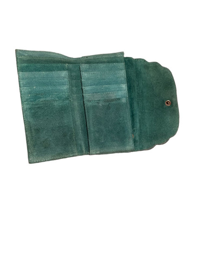 May include: A green leather wallet with multiple card slots and a fold-over closure.