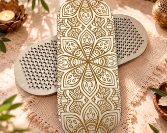 May include: A pair of oval-shaped wooden boards featuring a dense grid of sharp metal nails on one side. The top board displays a detailed gold-colored mandala pattern printed on its surface, while the bottom board shows the exposed metal nail tips.