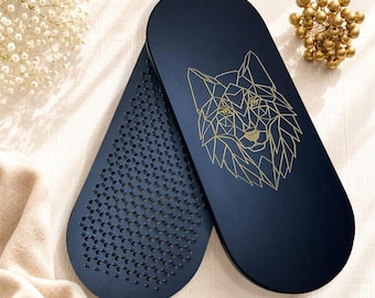 May include: Two oval-shaped dark blue boards featuring a geometric gold wolf head illustration on one surface and a dense grid of small, sharp metal spikes on the other. These boards are designed for standing, with a smooth finish and rounded edges.