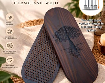 May include: A dark brown thermo ash wood Sadhu board with a tree engraving on the back. The board features a dense grid of metal nails arranged in a flower of life pattern. An inset graphic shows the nails move vertically via a spring system.