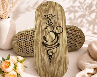 May include: Two oval-shaped wooden boards featuring a natural light brown wood grain finish. The front board displays a dark brown laser-engraved Om symbol topped with a lotus flower. The inner surfaces are covered in rows of small metal nails.