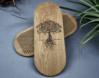 May include: Two wooden foot massage tools. One tool has a tree of life design burned into the wood. The other tool has a grid of small raised bumps.