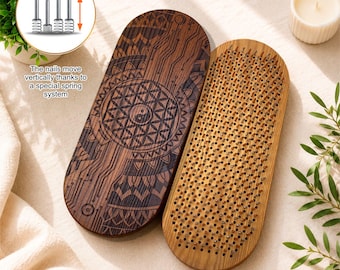 May include: Two oval wooden boards, one featuring a dark brown laser-engraved geometric pattern with a yin-yang symbol, and the other a lighter wood board embedded with numerous metal nails. The nails move vertically via a spring system.