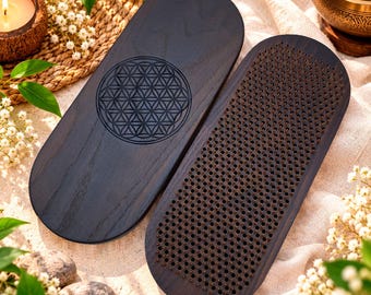 May include: Two oval dark wood boards, one featuring a laser-engraved flower of life geometric pattern on its surface and the other covered in a dense grid of sharp metal nails, designed for standing or foot pressure application.