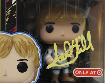 May include: A Funko Pop! vinyl figure of Luke Skywalker from Star Wars, number 453. The figure has a bobble-head design and is in its original packaging, with a signature and the text "ONLY AT Target".