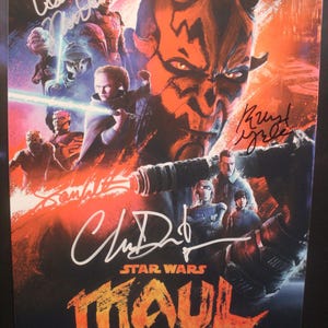 May include: Star Wars: Maul Shadow Lord poster featuring Darth Maul and other characters. The poster has multiple signatures in white ink. The title is in orange and yellow, with the Disney+ logo and April 6 date.