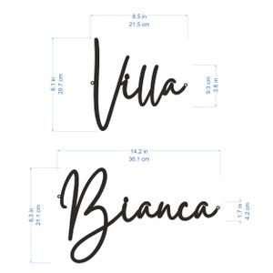 May include: Two black metal wall signs with the names "Villa" and "Bianca" in cursive script. The signs are 8.5 inches by 9.3 inches and 8.3 inches by 14.2 inches.