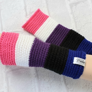May include: A pair of pink, white, purple, black and blue striped crocheted fingerless gloves with a white tag that says "Pridedc".