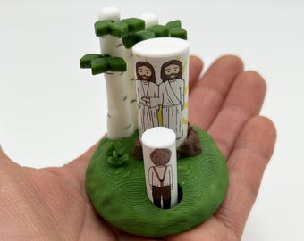 Puede incluir: Una escena impresa en 3D con dos figuras de pie frente a un abedul. Las figuras son blancas con cabello negro y visten túnicas blancas. El abedul es blanco con hojas verdes. La escena está ambientada en una base verde con un tronco de árbol marrón.