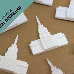 May include: A white 3D printed model of a temple, a popular religious building. The model is small and detailed, with intricate carvings and a tall spire. The model is ideal for a religious display or as a gift for a loved one.